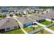 Aerial view of a home with a pool, patio, fenced yard, and surrounding neighborhood at 460 Lily Ln, Davenport, FL 33837