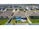 Aerial view of a home with a pool, patio, fenced yard in a neighborhood at 460 Lily Ln, Davenport, FL 33837