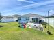 This backyard features a sandbox, fire pit, above ground pool and a covered patio at 460 Lily Ln, Davenport, FL 33837