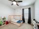 Bright bedroom with a unique wooden bed frame, wall decals, and functional storage solutions at 460 Lily Ln, Davenport, FL 33837