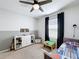 Bedroom featuring a ceiling fan, sports decor, a storage console, and a half wall two tone paint scheme at 460 Lily Ln, Davenport, FL 33837