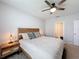 Bedroom showcases a neutral palette, with a bed featuring decorative pillows and lamps on either side at 460 Lily Ln, Davenport, FL 33837