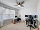 Bedroom with a ceiling fan, large window for natural light, and functional desk spaces at 460 Lily Ln, Davenport, FL 33837