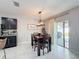 Cozy dining area with wood table, and sliding glass door bringing in light and access to the outdoor at 460 Lily Ln, Davenport, FL 33837