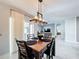 Dining area featuring wood table, modern chandelier, and sliding glass doors to let in natural light at 460 Lily Ln, Davenport, FL 33837