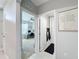 Hallway with an office visible on the left and a bathroom on the right showcasing functional spaces at 460 Lily Ln, Davenport, FL 33837