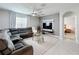 Comfortable living room with a large sectional sofa, modern ceiling fan, and mounted TV at 460 Lily Ln, Davenport, FL 33837