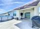 The covered patio includes a TV, furniture and an above ground pool at 460 Lily Ln, Davenport, FL 33837