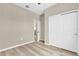 Neutral bedroom with hardwood floors, a window with a view, and a closet with sliding doors at 4955 Castle E St, Kissimmee, FL 34758