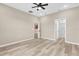 Spacious bedroom offers a ceiling fan, neutral walls and floors, and access to the ensuite bathroom at 4955 Castle E St, Kissimmee, FL 34758