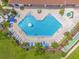 A bird's eye view of the community pool shows many lounge chairs and a small hot tub at 4955 Castle E St, Kissimmee, FL 34758