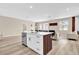 Open concept kitchen with white cabinetry, quartz countertops, an island with seating, and modern finishes throughout at 4955 Castle E St, Kissimmee, FL 34758