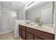 Bathroom featuring double sinks, a shower with glass doors, and modern fixtures at 5020 Ashford Falls Ln, Oviedo, FL 32765