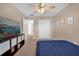 Bedroom with a ceiling fan, closet, and TV on a shelving unit at 5020 Ashford Falls Ln, Oviedo, FL 32765