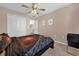 Bedroom featuring carpet, a ceiling fan, a closet, and decorations on the wall at 5020 Ashford Falls Ln, Oviedo, FL 32765