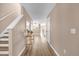 Inviting entryway featuring wood-look floors, staircase, decorative table, and a view into the living spaces at 5020 Ashford Falls Ln, Oviedo, FL 32765