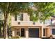 Charming two-story home featuring a well-maintained lawn, black door with wreath, and an attached garage at 5020 Ashford Falls Ln, Oviedo, FL 32765