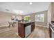 Modern kitchen with stainless steel appliances and granite countertops, seamlessly flowing into the dining area at 5020 Ashford Falls Ln, Oviedo, FL 32765