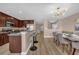 Open-concept kitchen featuring a breakfast bar, stainless steel appliances, and modern lighting fixtures at 5020 Ashford Falls Ln, Oviedo, FL 32765