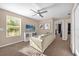 Bright living room featuring neutral tones, a ceiling fan, and plenty of natural light at 5020 Ashford Falls Ln, Oviedo, FL 32765