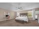 Spacious main bedroom featuring a large bed, a ceiling fan, and abundant natural light at 5020 Ashford Falls Ln, Oviedo, FL 32765