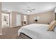 Large main bedroom featuring a ceiling fan, work space, and multiple doorways to the house at 5020 Ashford Falls Ln, Oviedo, FL 32765