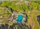 Aerial view of a community pool with palm trees, lounge chairs, and a covered seating area at 5020 Ashford Falls Ln, Oviedo, FL 32765