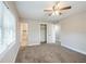 A bedroom with a walk-in closet, ceiling fan, and access to an ensuite bathroom at 5210 Grandview Dr, Orlando, FL 32808