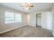 A comfortable bedroom with a ceiling fan, a window with blinds, and a spacious closet at 5210 Grandview Dr, Orlando, FL 32808