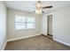 Cozy bedroom with neutral carpet, ceiling fan and large window at 5210 Grandview Dr, Orlando, FL 32808