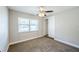 A well-lit bedroom with a ceiling fan, carpet, a closet and large window with blinds at 5210 Grandview Dr, Orlando, FL 32808