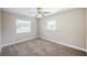 A bright bedroom with neutral walls, a carpeted floor, and two windows bringing in natural light at 5210 Grandview Dr, Orlando, FL 32808