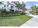 Beautifully landscaped entrance to the building with manicured green grass and walkway to the lobby at 530 E Central Blvd # 501, Orlando, FL 32801