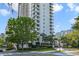 Towering condominium building with meticulous landscaping, palm trees and sunny blue skies at 530 E Central Blvd # 501, Orlando, FL 32801