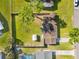 Bird's eye view showing the fully-fenced backyard with patio, mature trees, and shed at 536 Ellerbe Way, Lakeland, FL 33801