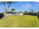 Expansive backyard with lush lawn, mature tree, storage shed, and wood fence at 536 Ellerbe Way, Lakeland, FL 33801