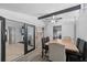 Dining area with exposed brick wall, modern light fixture, and convenient access to living spaces at 536 Ellerbe Way, Lakeland, FL 33801