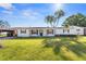 Charming single-story home with a well-manicured lawn and classic black and white color scheme at 536 Ellerbe Way, Lakeland, FL 33801