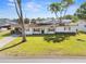 Charming single-story home with a well-manicured lawn and classic black and white color scheme at 536 Ellerbe Way, Lakeland, FL 33801