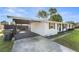 Side exterior featuring a covered parking area and a glimpse of the home's facade at 536 Ellerbe Way, Lakeland, FL 33801