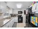 Bright kitchen featuring granite countertops, white cabinets, and modern appliances at 536 Ellerbe Way, Lakeland, FL 33801