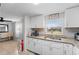 Well-lit kitchen with granite countertops and white cabinetry; dining area is just steps away at 536 Ellerbe Way, Lakeland, FL 33801