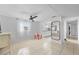 Open-concept living room with tile flooring, a ceiling fan and natural light at 536 Ellerbe Way, Lakeland, FL 33801