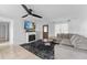 Cozy living room featuring a fireplace, ceiling fan and comfortable seating at 536 Ellerbe Way, Lakeland, FL 33801