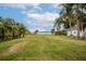 Expansive backyard with a beautiful view of the water and palm trees at 5790 Crystal Beach Rd, Winter Haven, FL 33880