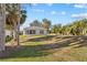 Home exterior showing a screened lanai, a spacious yard and verdant landscaping at 5790 Crystal Beach Rd, Winter Haven, FL 33880