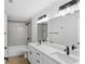 Modern bathroom featuring a double vanity, quartz countertop, framed mirror, and tiled shower at 5790 Crystal Beach Rd, Winter Haven, FL 33880