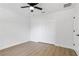 A well-lit bedroom featuring a ceiling fan, closet, and wood-look flooring at 5790 Crystal Beach Rd, Winter Haven, FL 33880