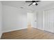 Neutral-toned bedroom with wood flooring and a closet with bi-fold doors at 5790 Crystal Beach Rd, Winter Haven, FL 33880