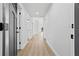 Bright hallway with wood-look flooring, leading to various rooms in the home at 5790 Crystal Beach Rd, Winter Haven, FL 33880